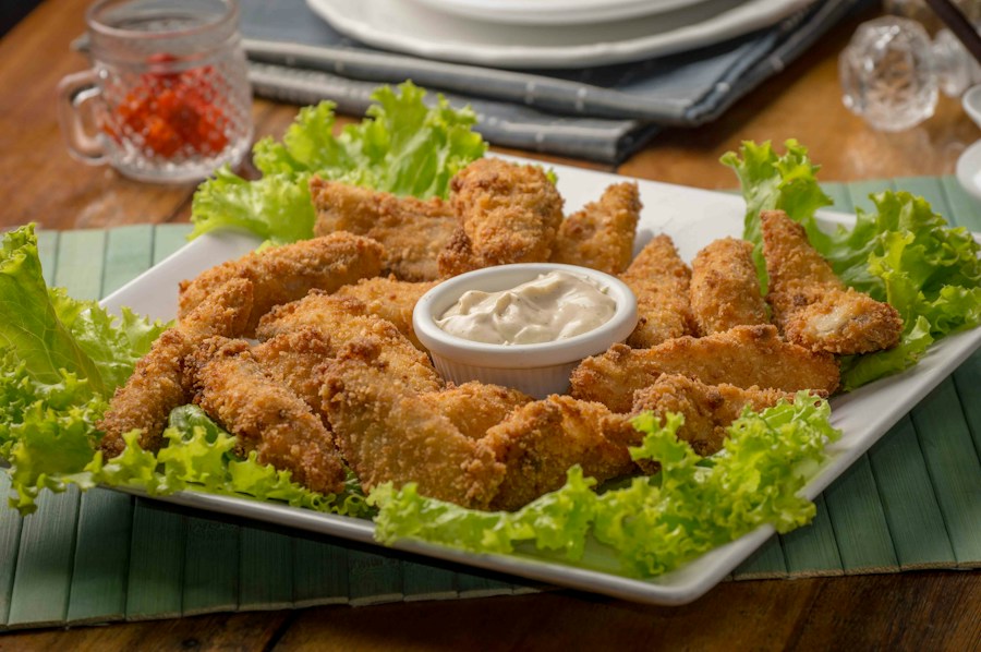 Golden crispy chicken bites with dipping sauce